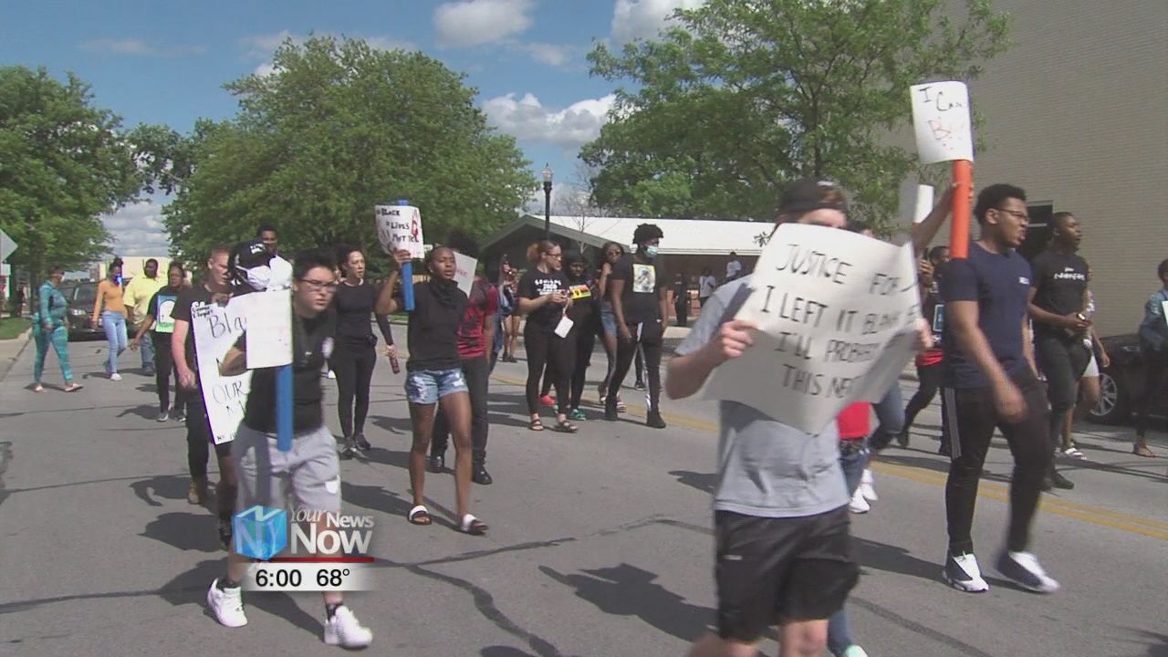 Protesters chant "NO JUSTICE, NO PEACE" as they march through downtown Lima